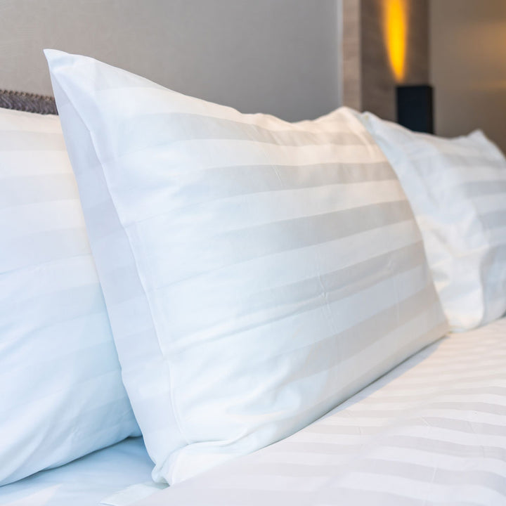 The Hotel Collection Satin Stipe Pair Of Pillows on a bed