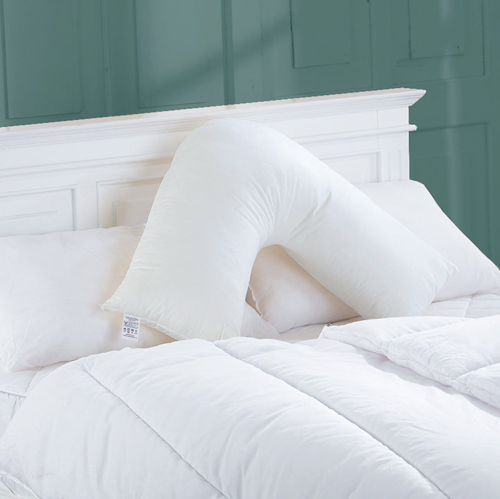 Hollowfibre filled V Shape Pillow on a double bed with pillows and duvet