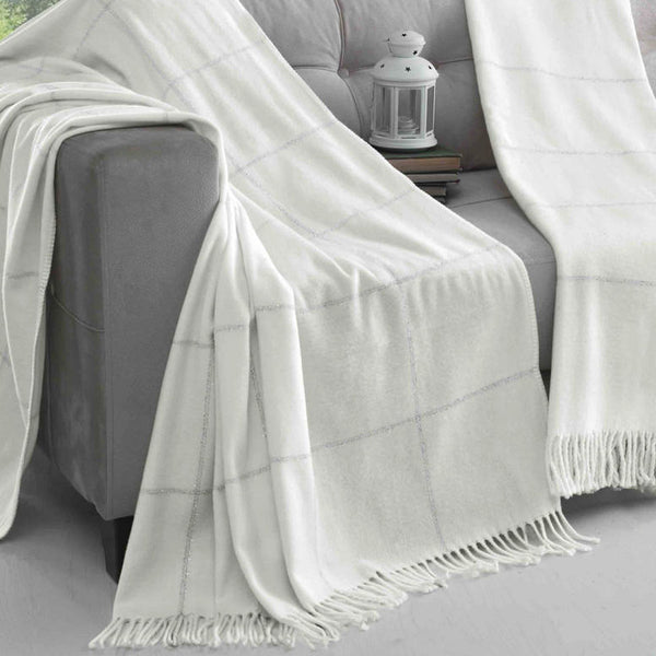 White and silver checked 150cm x 200cm scotch blanket draped over a grey sofa