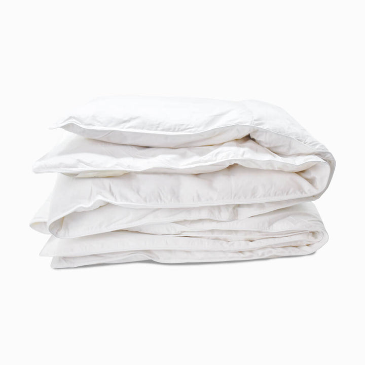 10.5 tog goose feather and goose down duvet with 100% cotton case, folded and isolated on a white background