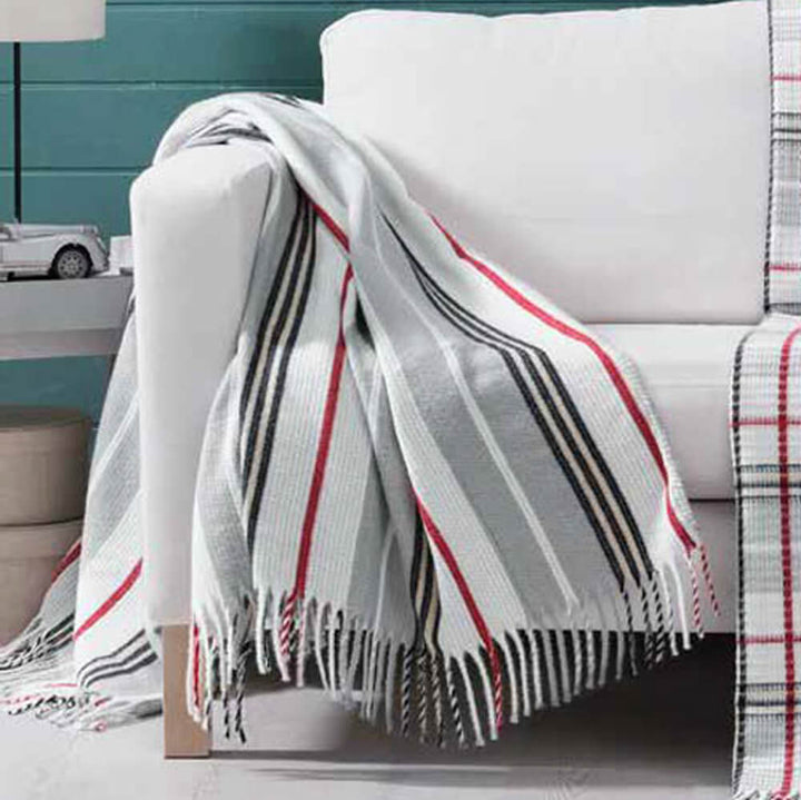 Red, grey, navy and white striped 150cm x 200cm blanket draped over a sofa arm