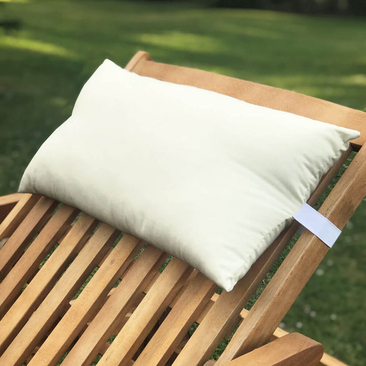 Lancashire Textiles Cream Sun Lounger Pillow secured to a wooden sun lounger with elasticated strap