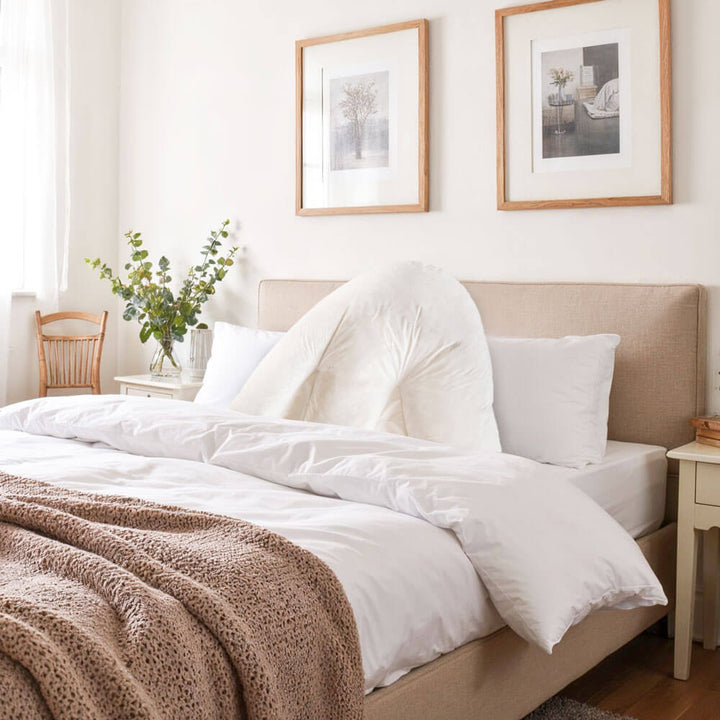 Duck Feather Filled Batwing Pillow on a bed