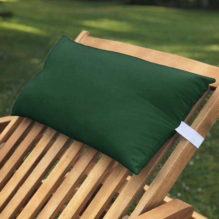 Lancashire Textiles bottle green Sun Lounger Pillow secured to a wooden sun lounger with elasticated strap