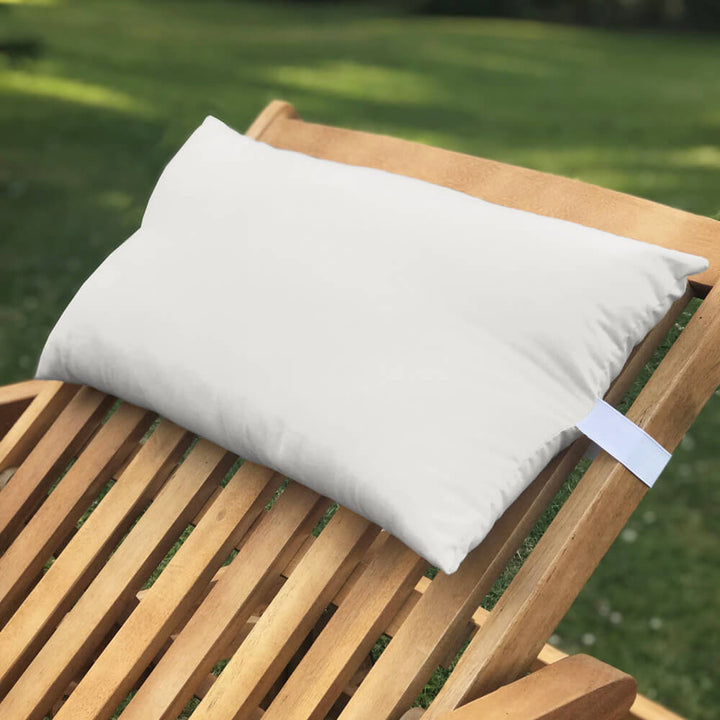 Lancashire Textiles light grey Sun Lounger Pillow secured to a wooden sun lounger with elasticated strap