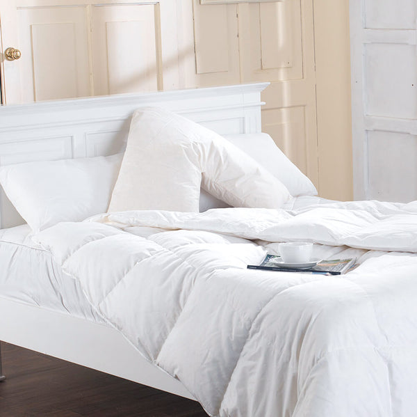 Duck Feather Filled V shape pillow with 100% cotton case on a bed with pillows and duvet