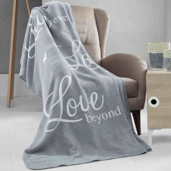 Grey and white fleece blanket with typography of Love