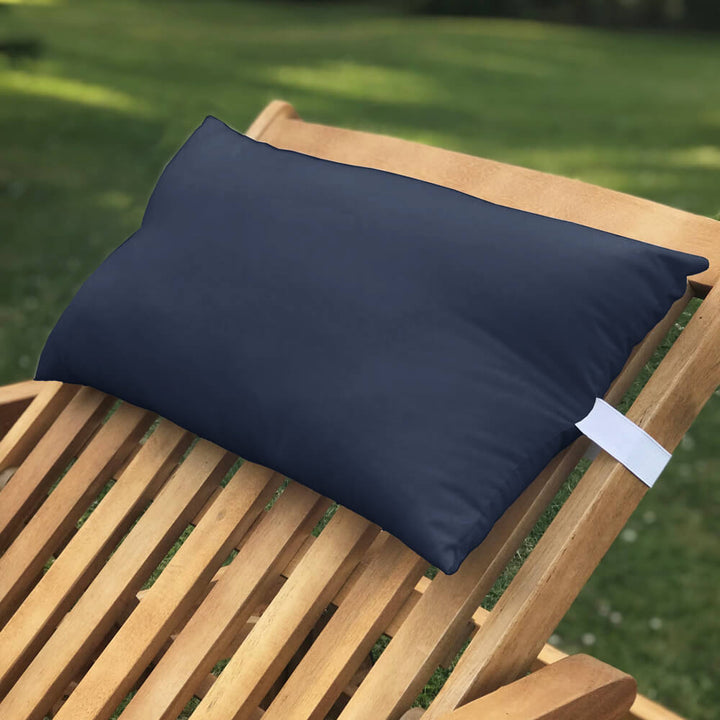 Lancashire Textiles navy blue Sun Lounger Pillow secured to a wooden sun lounger with elasticated strap