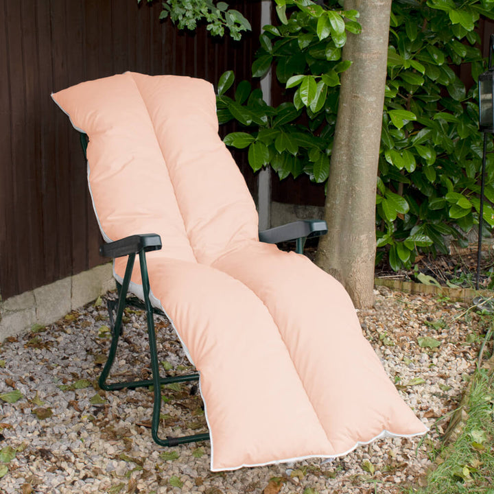 Lancashire Textiles peach Sun Lounger Topper on a metal sun lounger recliner in a garden. 