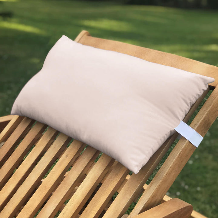 Lancashire Textiles peach coloured Sun Lounger Pillow secured to a wooden sun lounger with elasticated strap