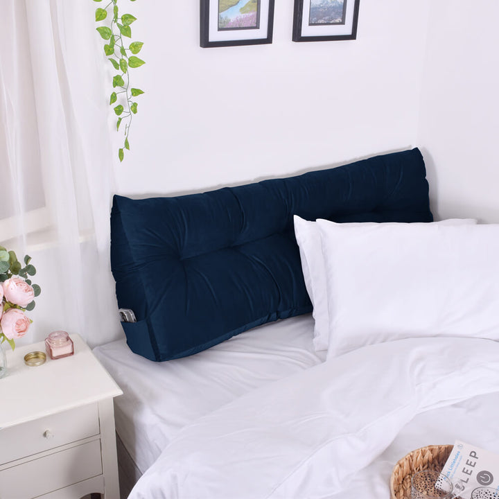 Peacock Blue Velvet Headboard Wedge on a bed with a phone in the side pocket