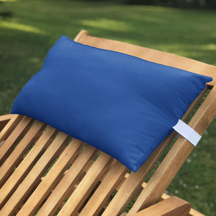 Lancashire Textiles royal blue Sun Lounger Pillow secured to a wooden sun lounger with elasticated strap