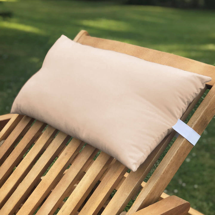 Lancashire Textiles sand coloured Sun Lounger Pillow secured to a wooden sun lounger with elasticated strap