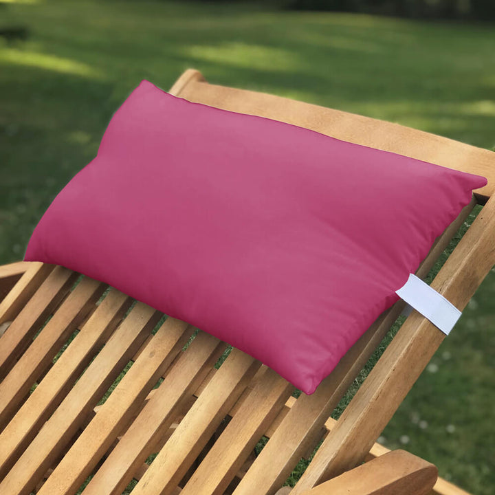 Lancashire Textiles wine coloured Sun Lounger Pillow secured to a wooden sun lounger with elasticated strap